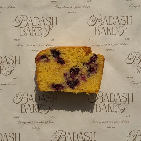 slice of blueberry cornbread loaf on badash bakery sheet